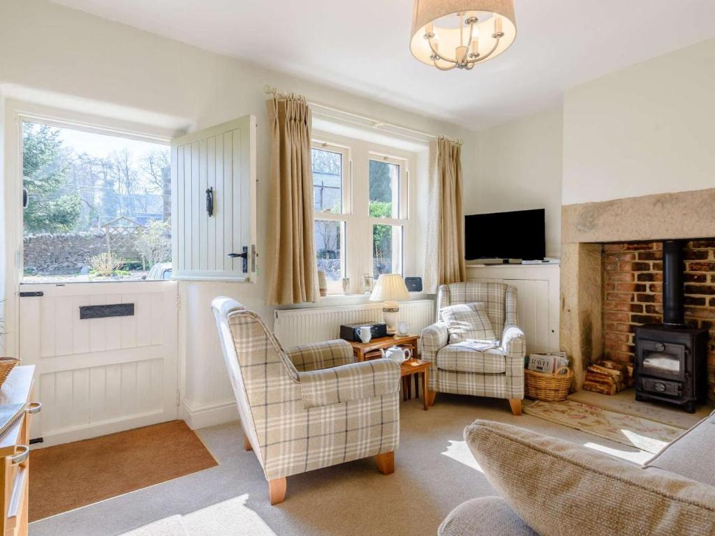 a living room with two chairs and a fireplace at 2 Bed in Bakewell oc-pk894 in Bakewell