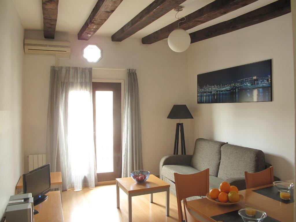 a living room with a couch and a table at My Address in Barcelona Downtown in Barcelona