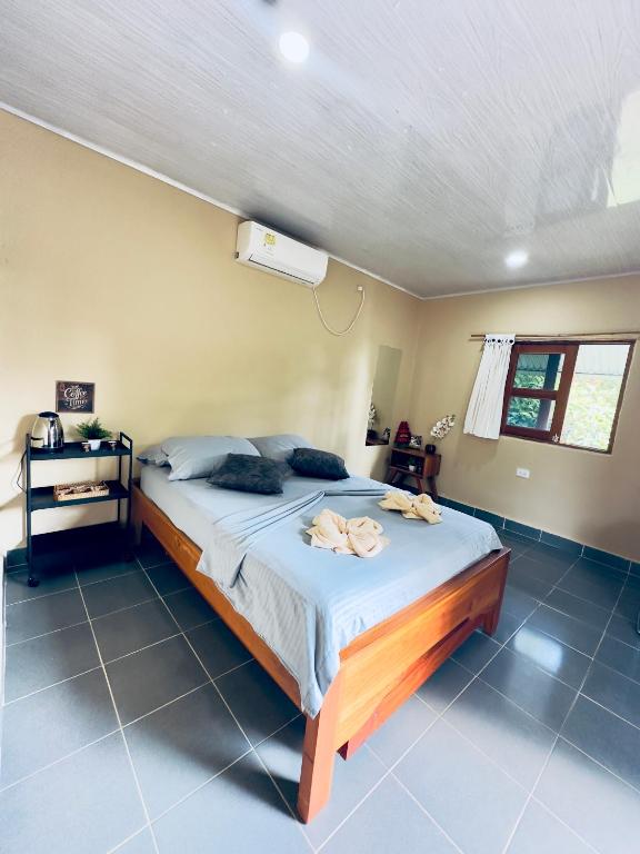 a bedroom with a large bed in a room at Cabañas San Jose in Doradal
