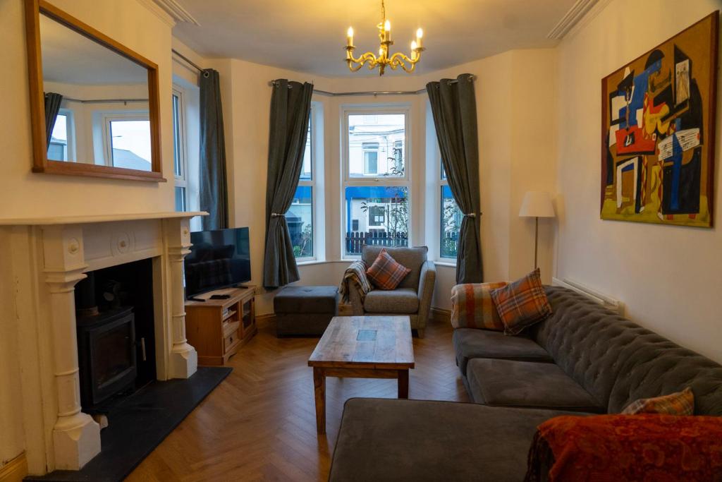 a living room with a couch and a fireplace at The Red Door in Bangor
