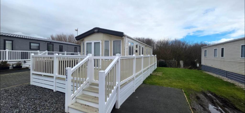 a house with a white railing and a porch at Joy & Mick's Happy Place in Morecambe