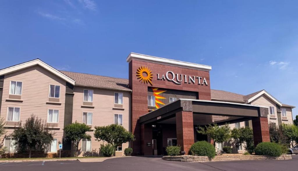 a hotel with a sun sign on the front of it at La Quinta by Wyndham Moscow Pullman in Moscow