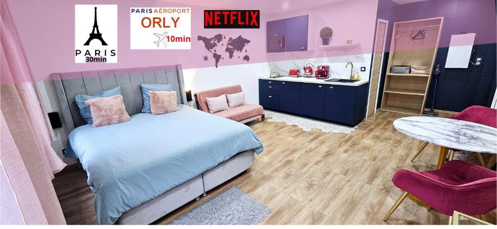 a bedroom with a bed and a sink and a table at Escapade Parisienne - PARIS ORLY in Orly
