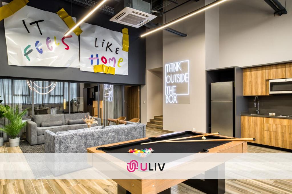 a living room with a ping pong table in the middle at ULIV Cibeles in Mexico City