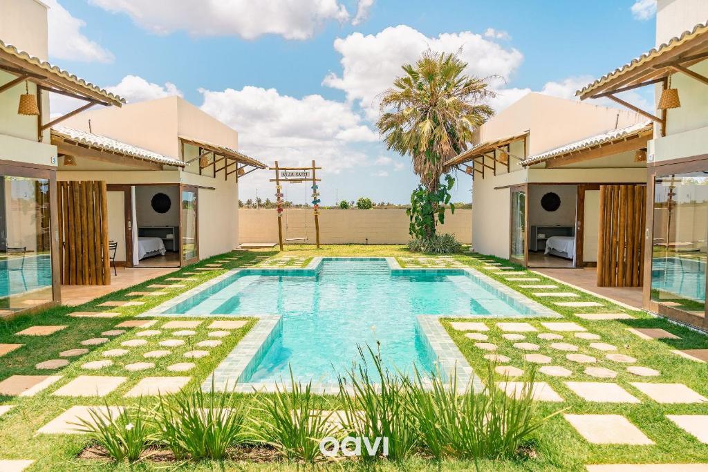 a swimming pool in the backyard of a villa at Villa Kaitei in São Miguel do Gostoso