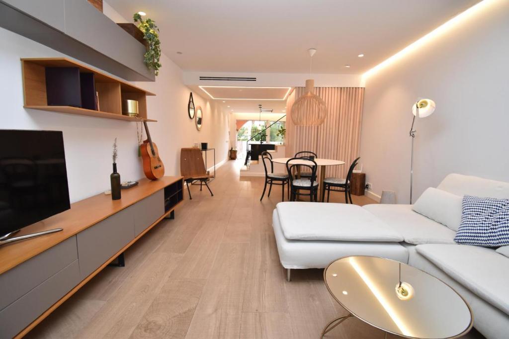 a living room with a white couch and a tv at Barocco Villa private pool in Santa Pola