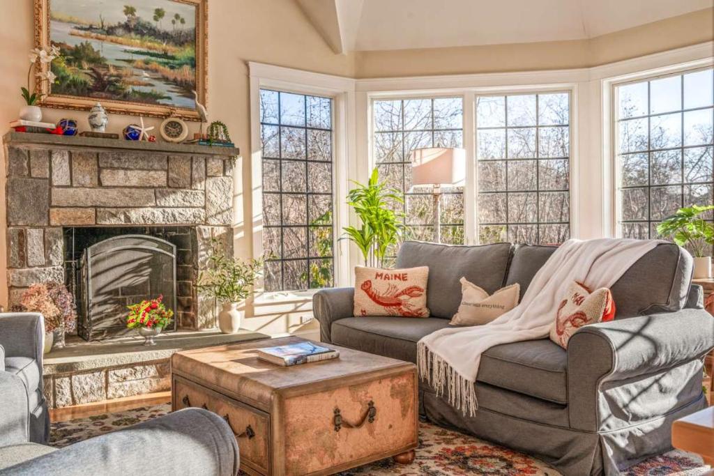 a living room with a couch and a fireplace at Town & Tide Home for 8 in Kennebunkport