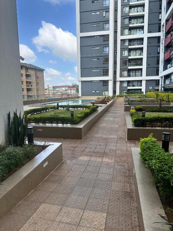 a walkway in the middle of a large building at BlaQ Homes in Kanga