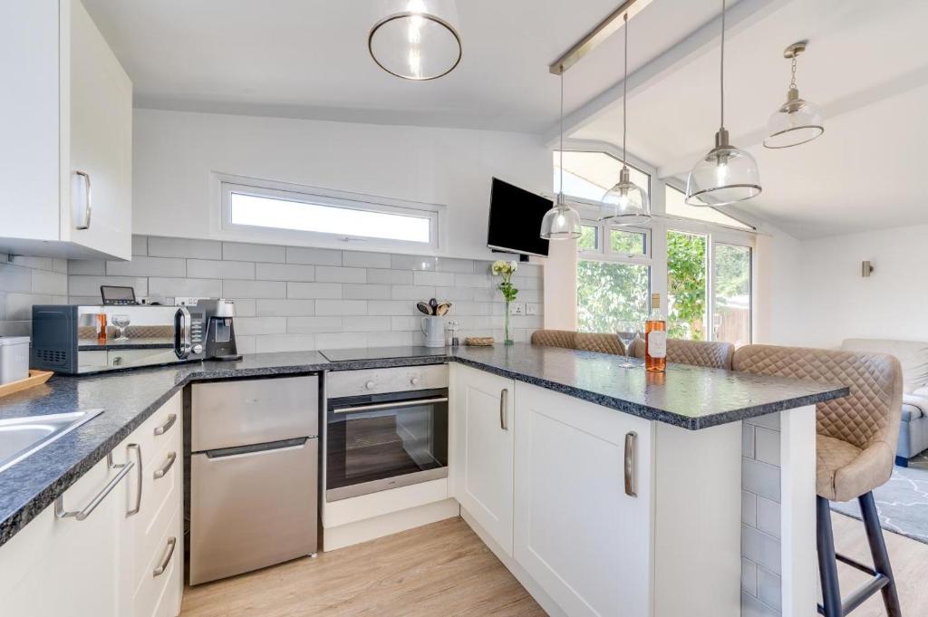 a kitchen with white cabinets and a counter top at 2 Bed in Caswell Bay oc-hh379 in Newton