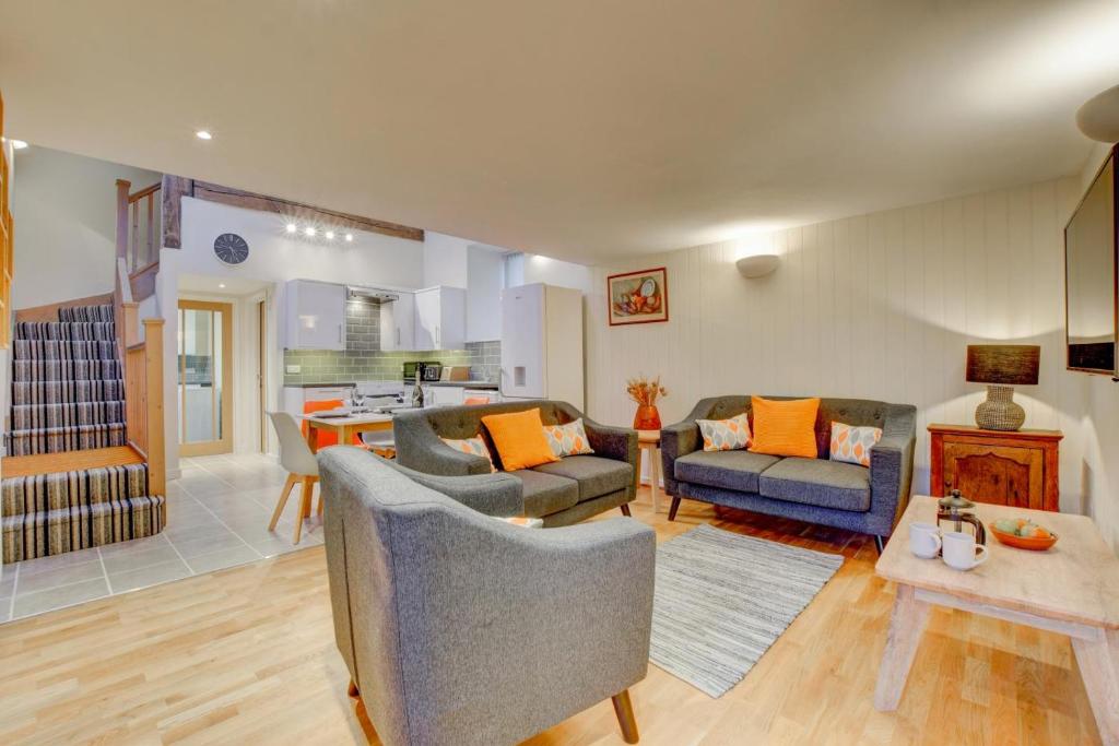 a living room with two couches and a kitchen at 3 Bed in Machynlleth oc-bow91 in Penegoes