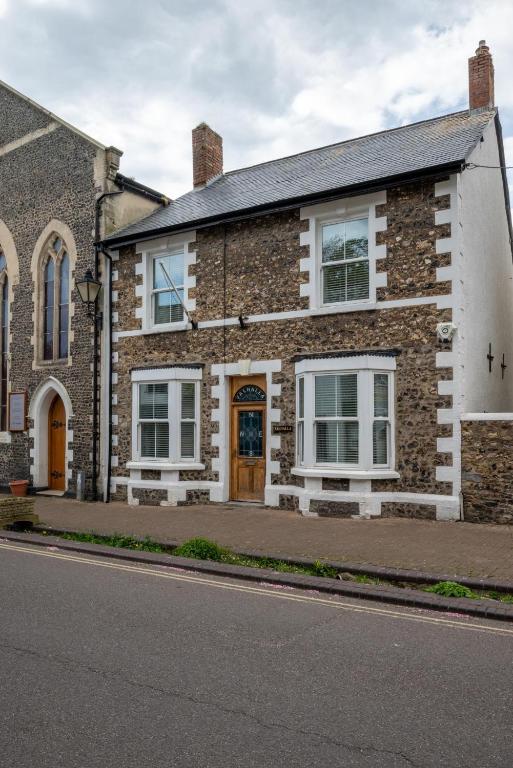 a brick house with white windows on a street at 3 Bed in Beer oc-jbvalh in Beer