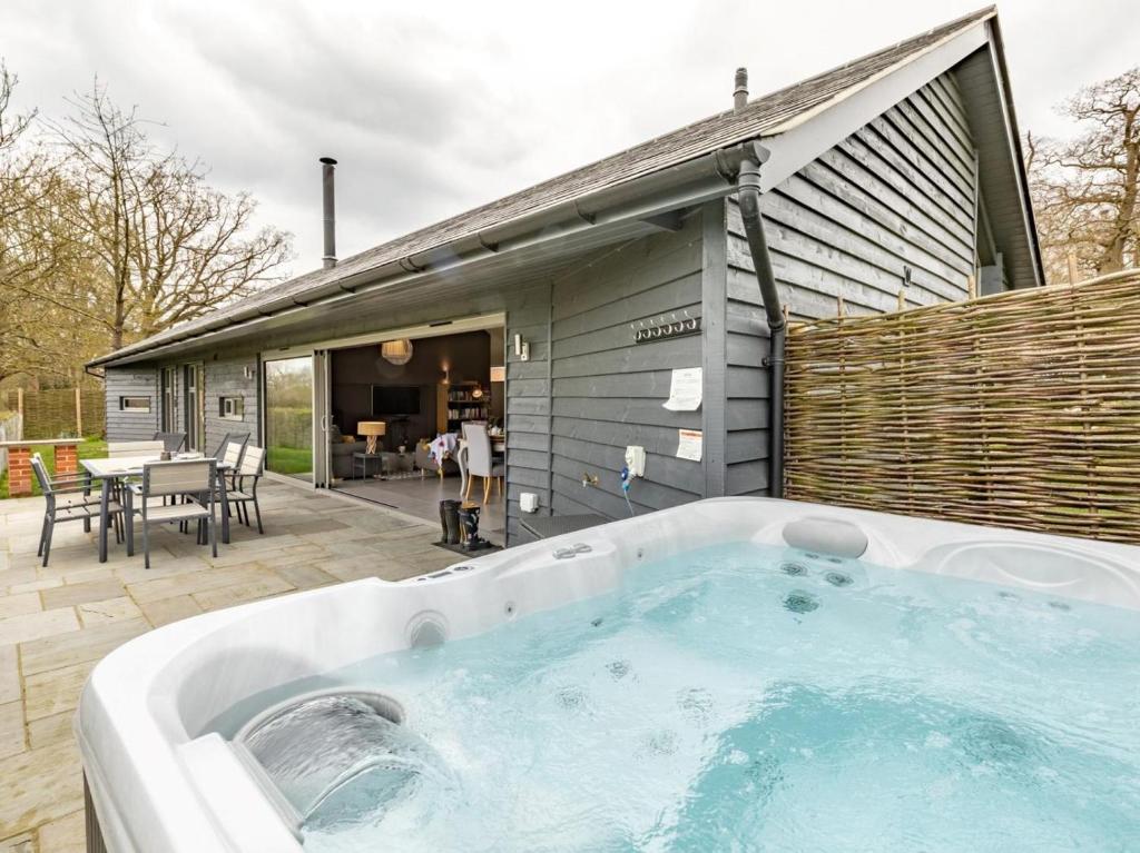 a large hot tub in front of a house at 2 Bed in Diss oc-51468 in Wortham