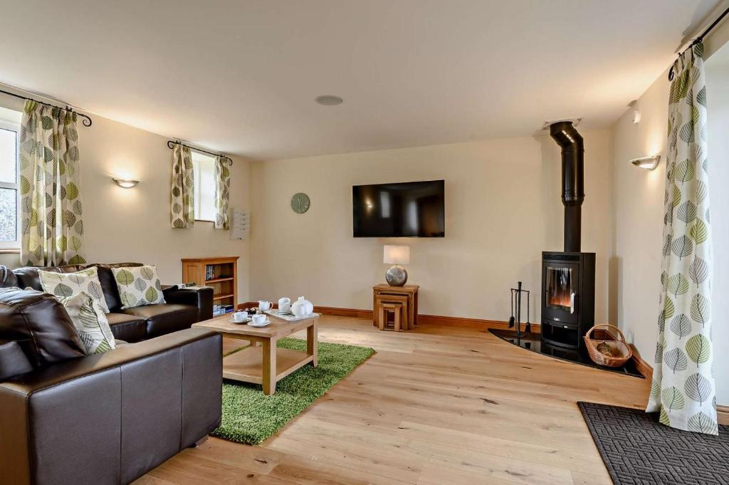 a living room with a couch and a fireplace at 2 Bed in Gilwern oc-o27004 in Gilwern