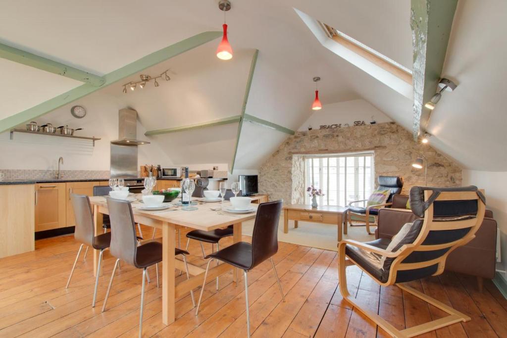 a kitchen and dining room with a wooden table and chairs at 3 Bed in Beer oc-jbgall in Beer