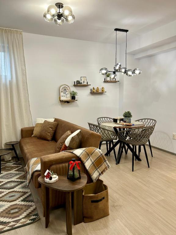a living room with a couch and a table at Aba Fly & Rest in Otopeni