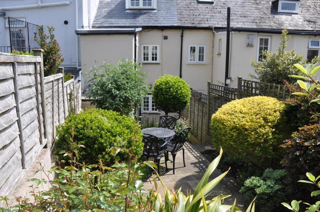 a garden with a table and chairs in front of a house at 2 Bed in Seaton oc-b27402 in Seaton