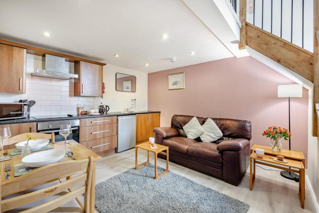 a living room with a couch and a kitchen at 1 Bed in Berwick-upon-Tweed oc-a32026 in Kyloe
