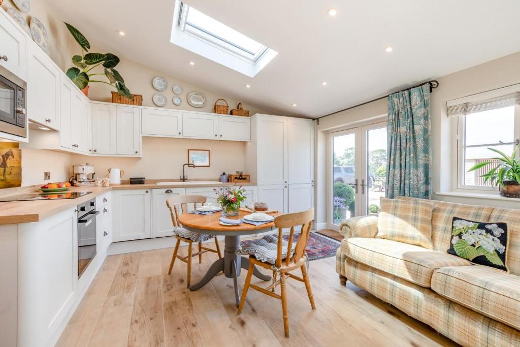 a kitchen and living room with a table and a couch at 1 Bed in Ashton oc-p30484 in Ashton