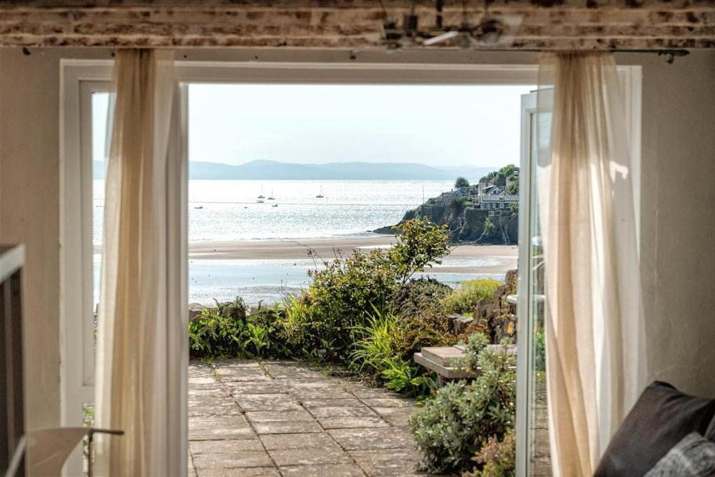 a room with a view of the beach through a window at 2 Bed in Pwllheli oc-glanab in Abersoch
