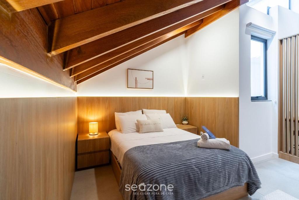 a bedroom with a large bed with wooden walls at Modern studio in Downtown Floripa CMA0101 in Florianópolis