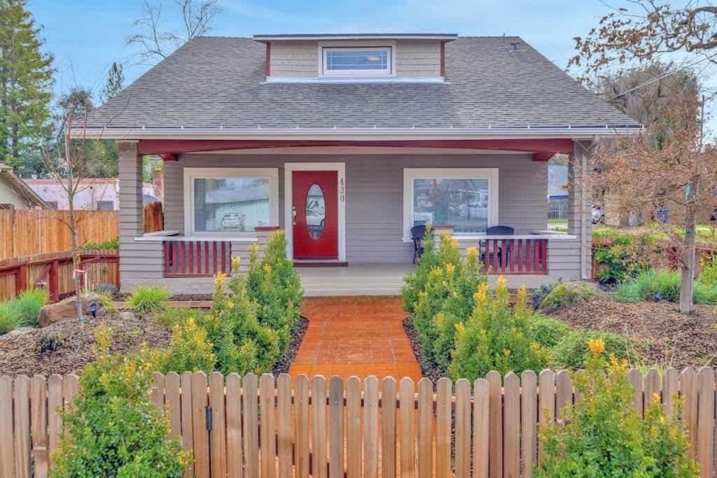 a small house with a red door and a fence at Home Squared-Downtown with Fire Pit in Paso Robles