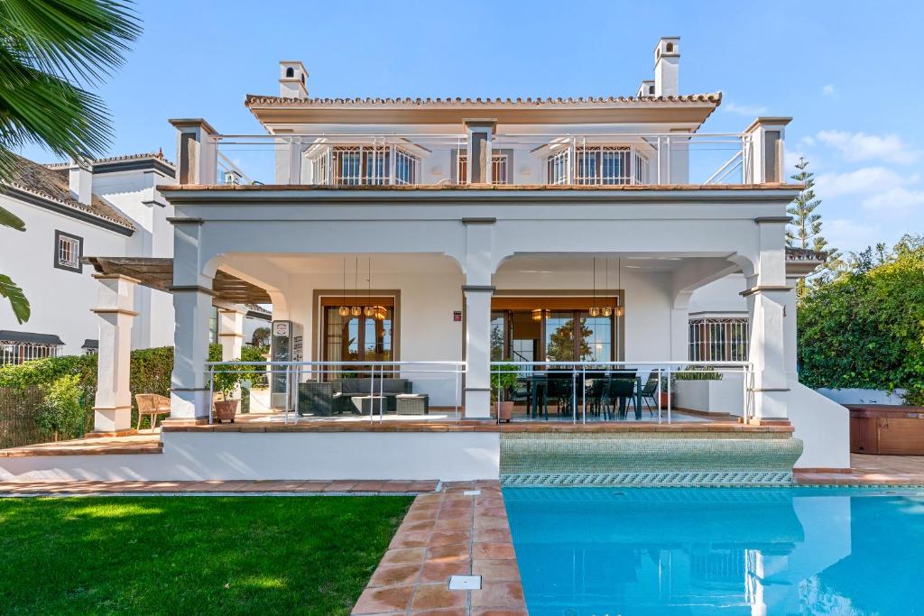 a house with a swimming pool in front of a house at Villa Picasso Marbella in Marbella