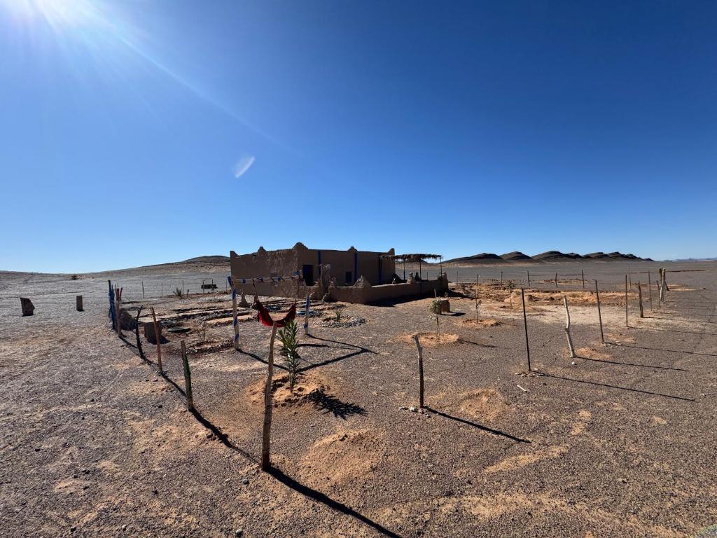 a desert with a fence in the middle of a field at Guest House For Rent Merzane in Merzane