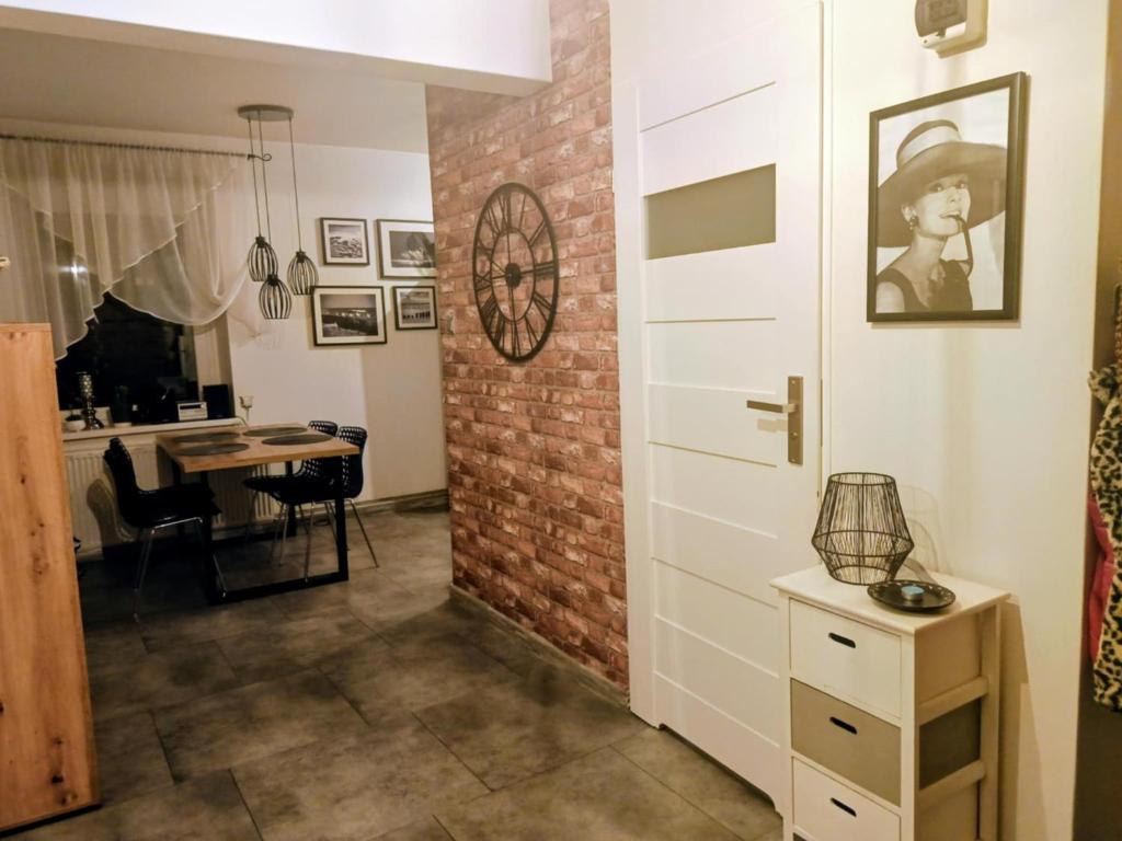 a room with a brick wall and a door at APaRTAMENT MOUTAIN SKY in Świeradów-Zdrój