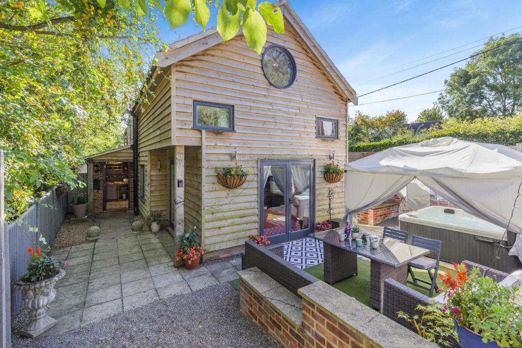 a house with a clock on the side of it at 5 Bed in Blofield oc-s33037 in Blofield