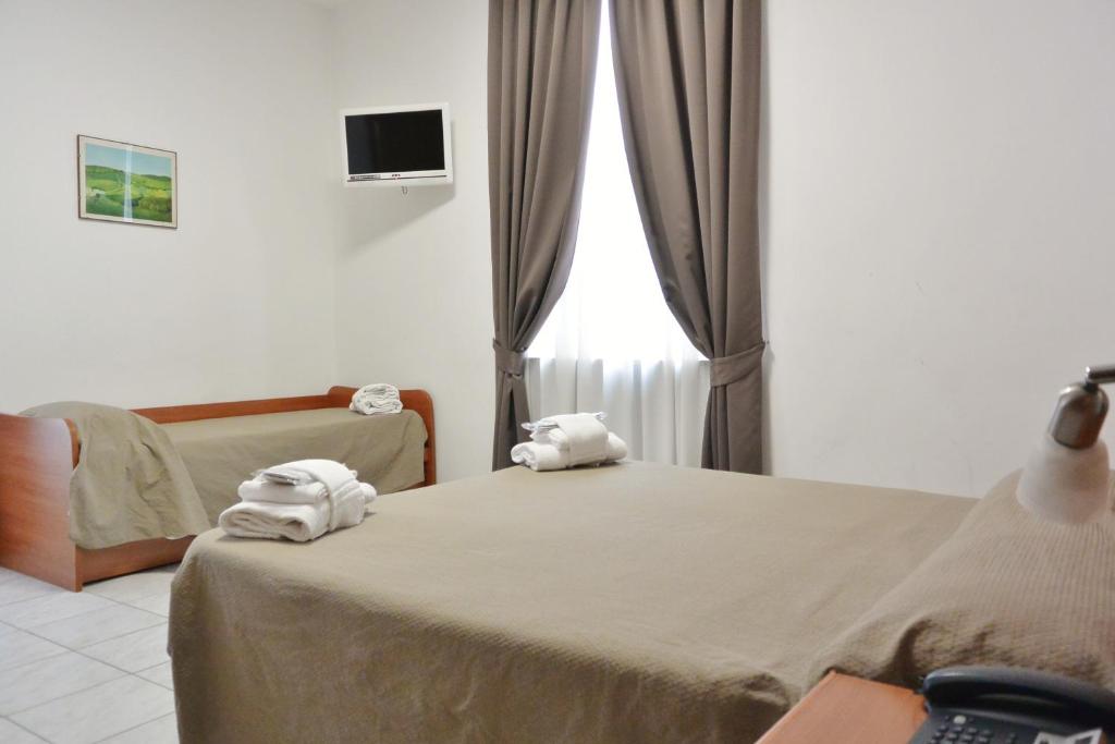 Postel nebo postele na pokoji v ubytování Hotel Trentina