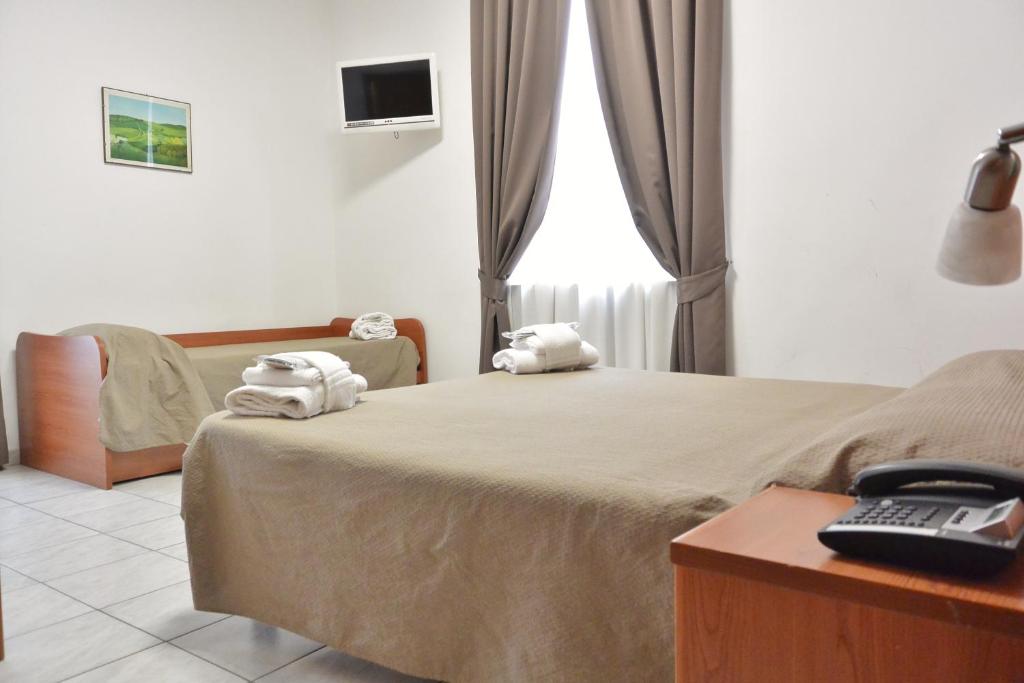 Postel nebo postele na pokoji v ubytování Hotel Trentina