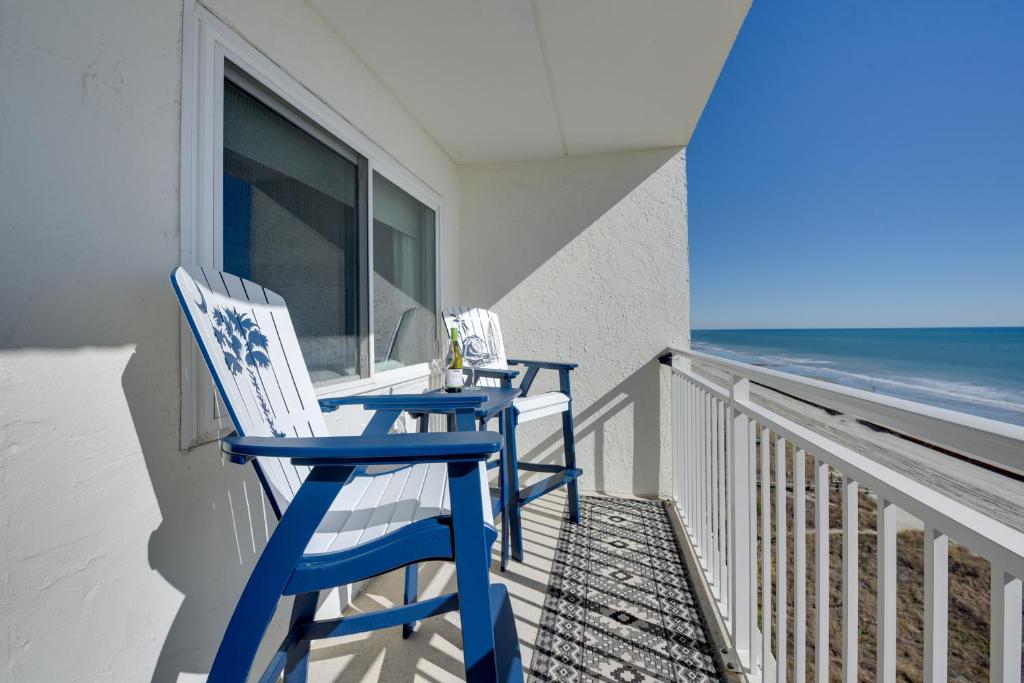 two blue chairs sitting on a balcony overlooking the ocean at Beach, Pool & Ocean View! North Myrtle Beach Condo in Myrtle Beach