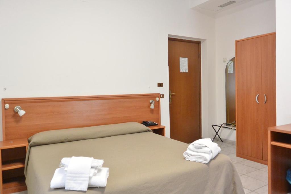 Postel nebo postele na pokoji v ubytování Hotel Trentina