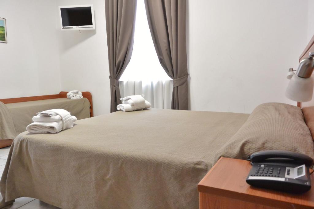 Postel nebo postele na pokoji v ubytování Hotel Trentina