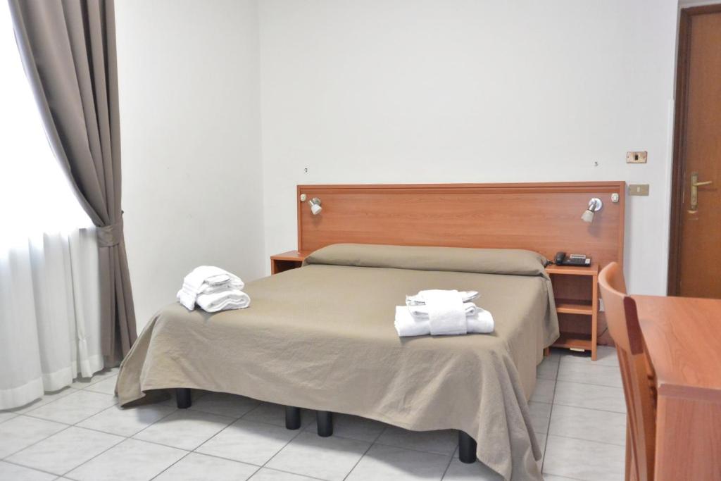 Postel nebo postele na pokoji v ubytování Hotel Trentina