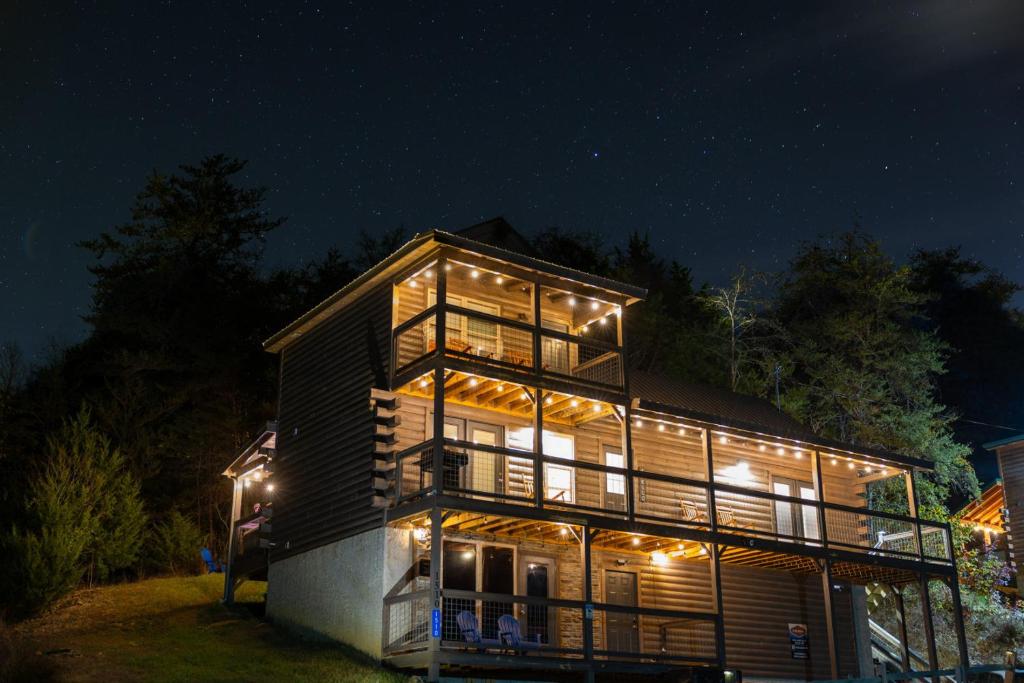 a house lit up at night with lights at Afterglow by Ghosal Luxury Lodging in Sevierville
