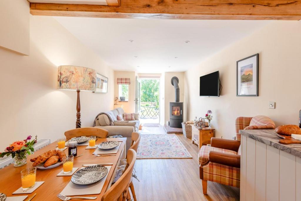 a living room with a table and chairs and a living room at 2 Bed in Caldbeck oc-a32049 in Caldbeck