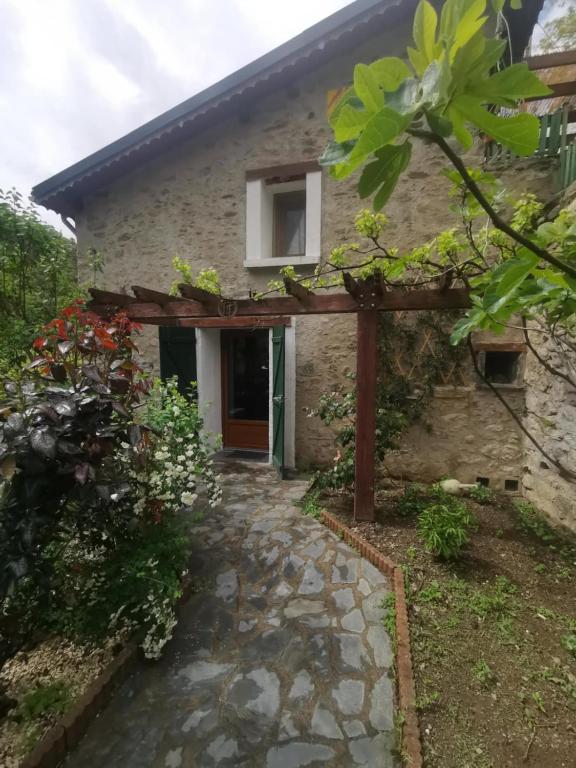 an external view of a stone house with a pathway at La maison du meunier in Olette