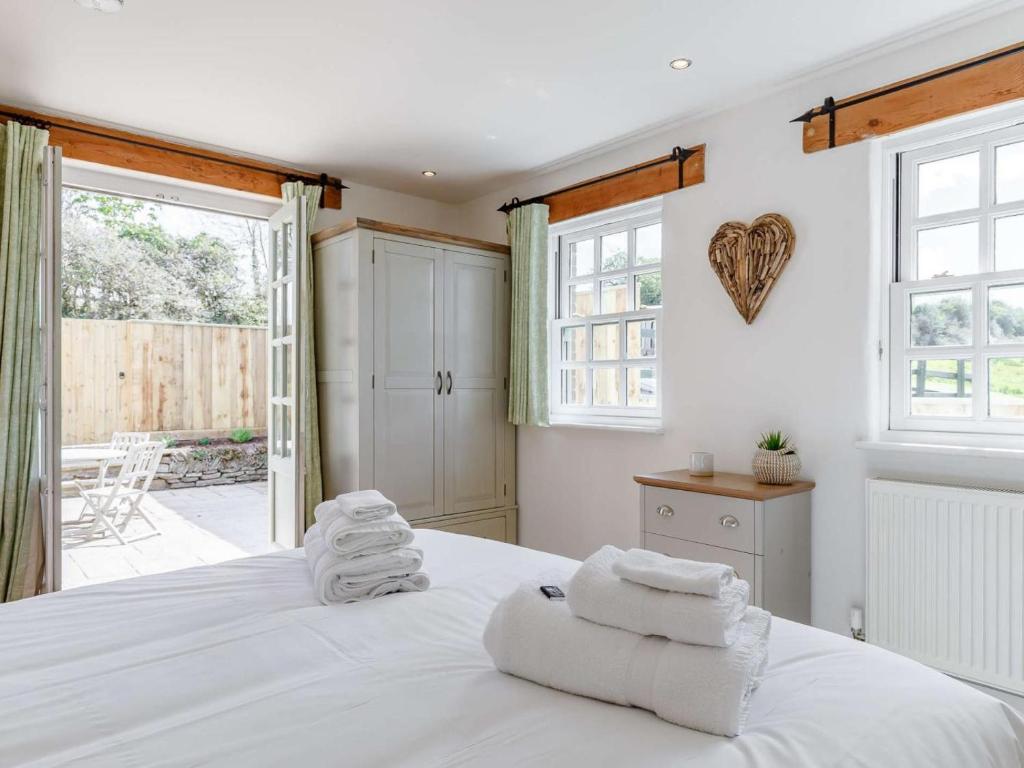 a bedroom with a white bed with towels on it at 2 Bed in Wadebridge oc-82682 in Little Petherick