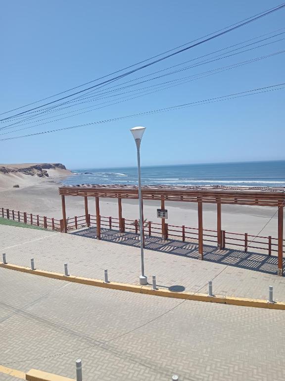 a view of a beach with a pier and the ocean at La Casa Del Hombre in Puerto Chicama