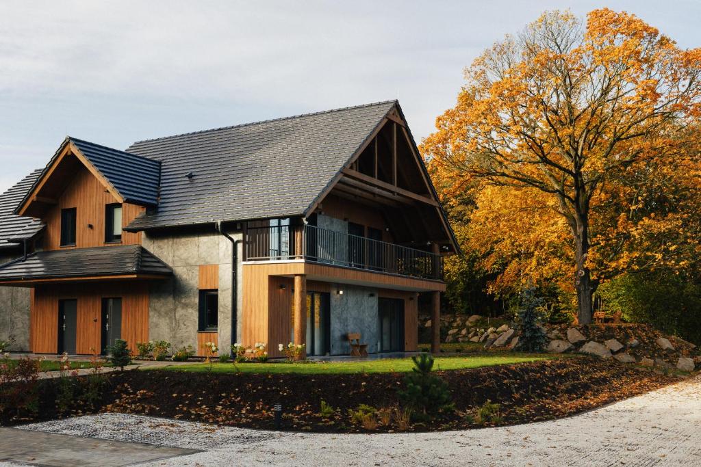 a house with a black roof at Apartamenty Greenwood in Staniszów