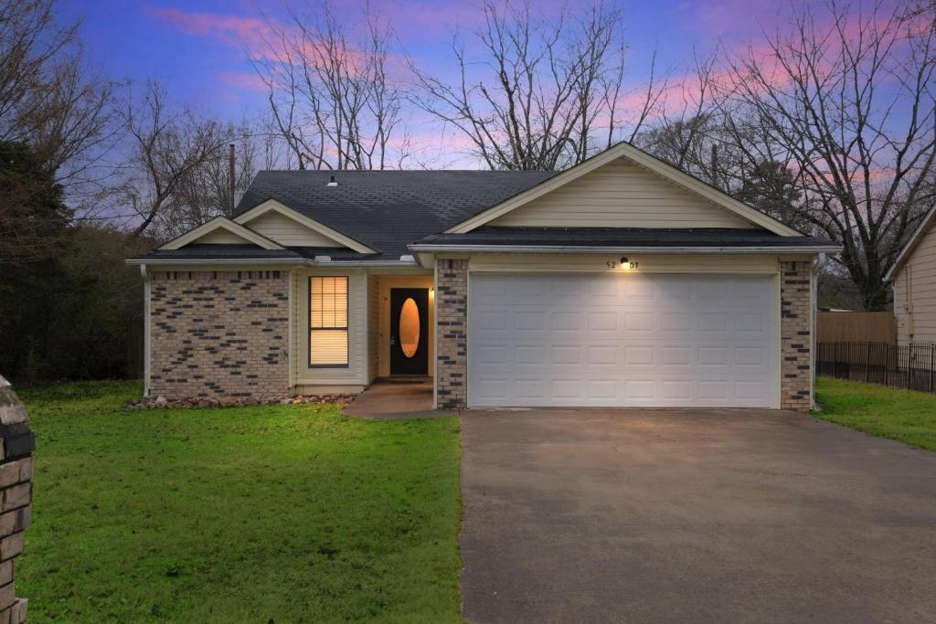a house with a garage in a yard at Uptown Serenity in North Little Rock