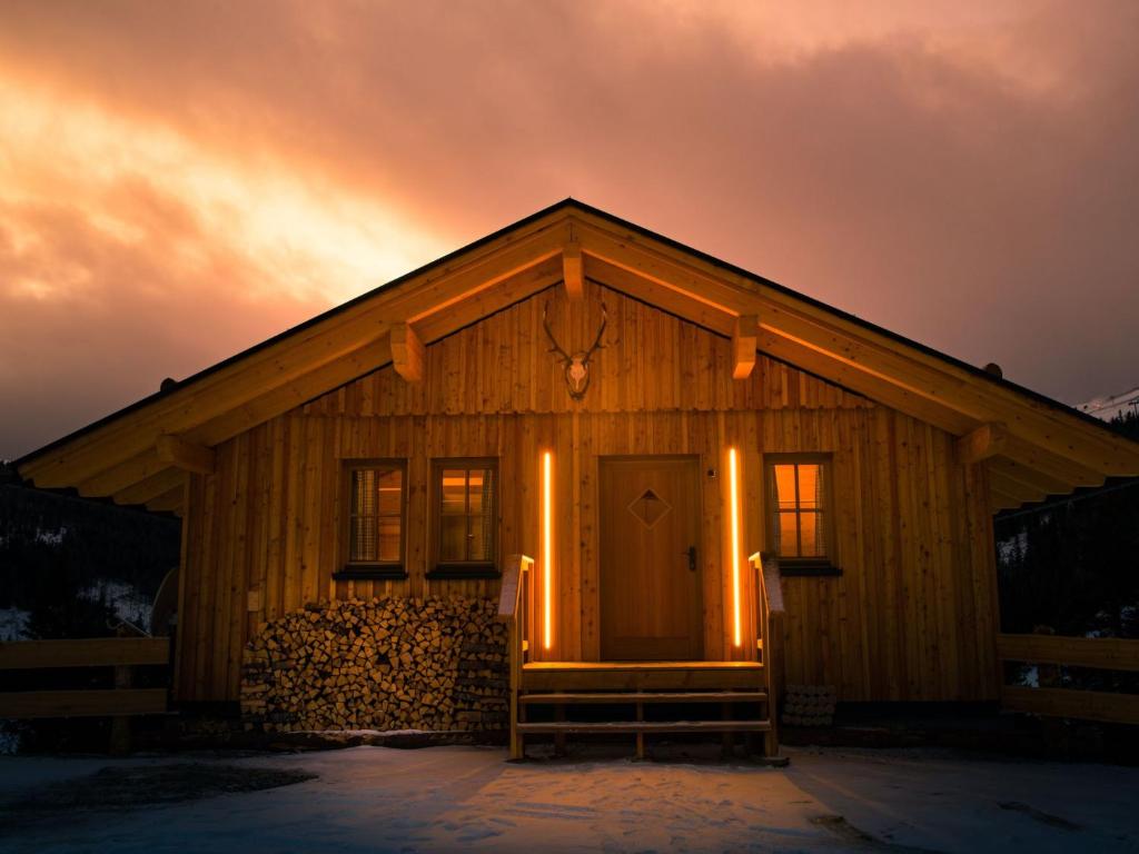 a wooden cabin with a front door at sunset at Holiday Home Jagdhütte by Interhome in Lachtal