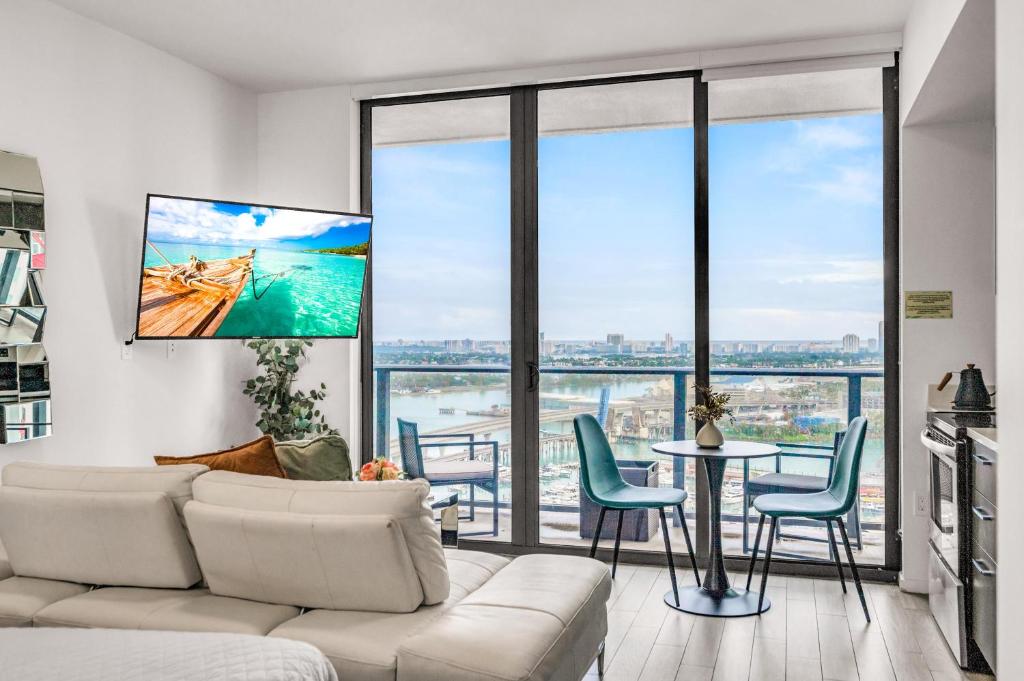 a living room with a couch and a table with chairs at Bay Views Studio in Miami
