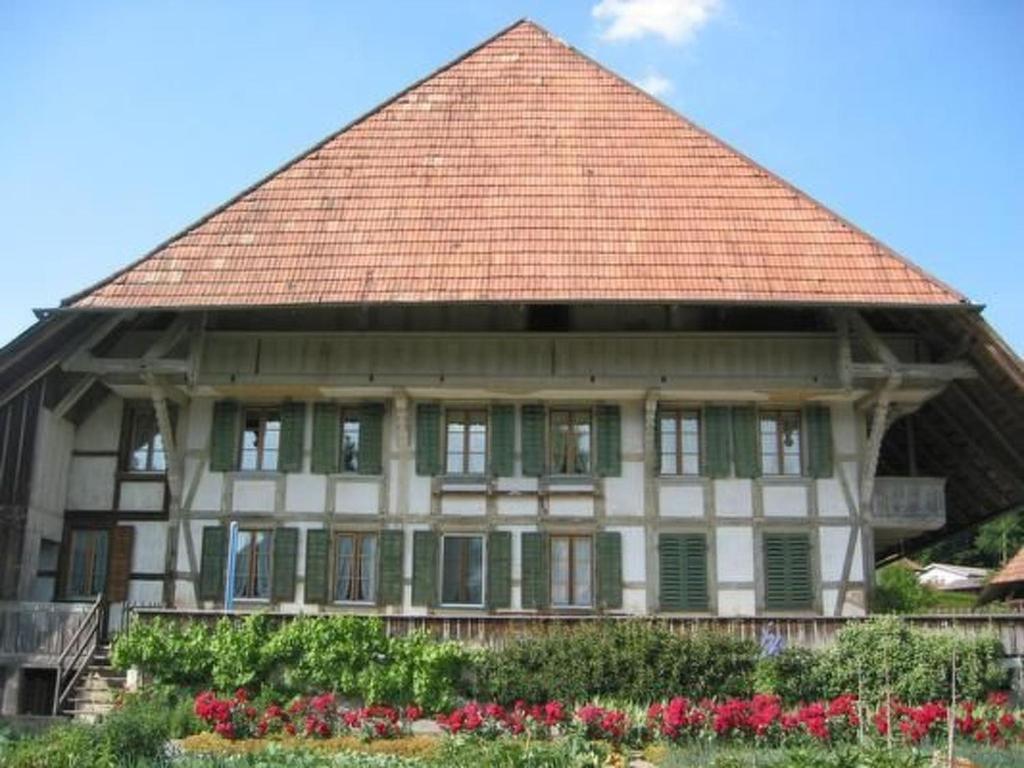 a building with a roof with flowers in front of it at Apartment Leinacherhof by Interhome in Seeberg