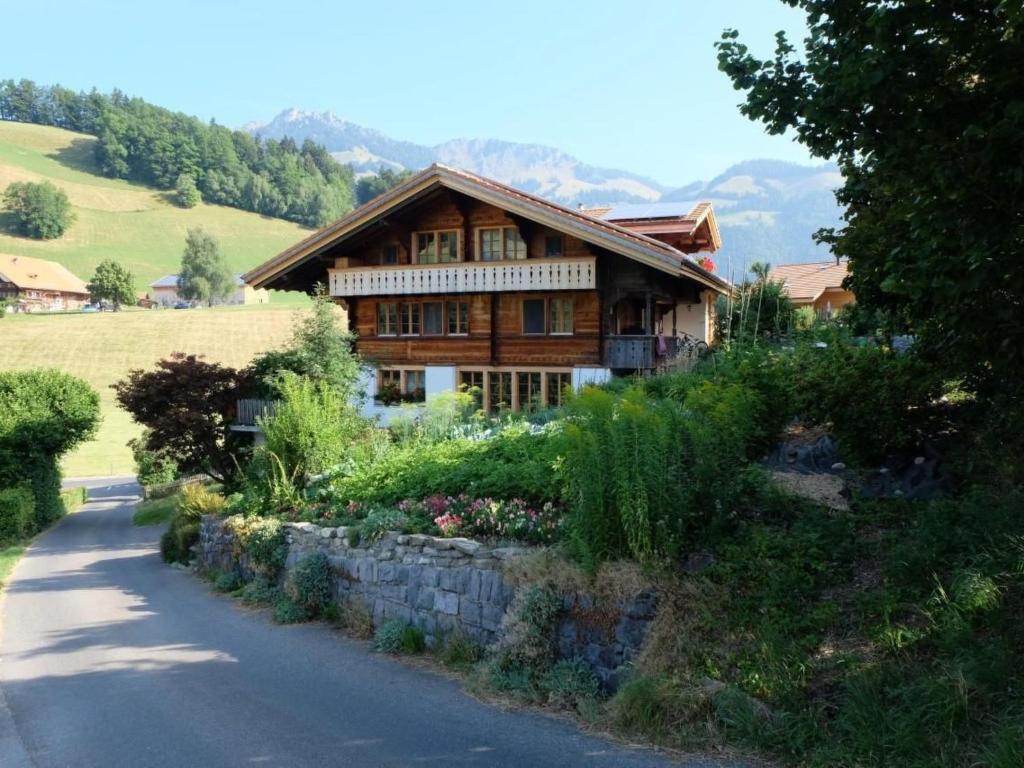 a house on a hill next to a road at Apartment Chalet Ried by Interhome in Diemtigen