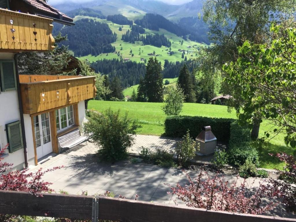 a house with a view of a green valley at Apartment Frohmatt by Interhome in Adelboden