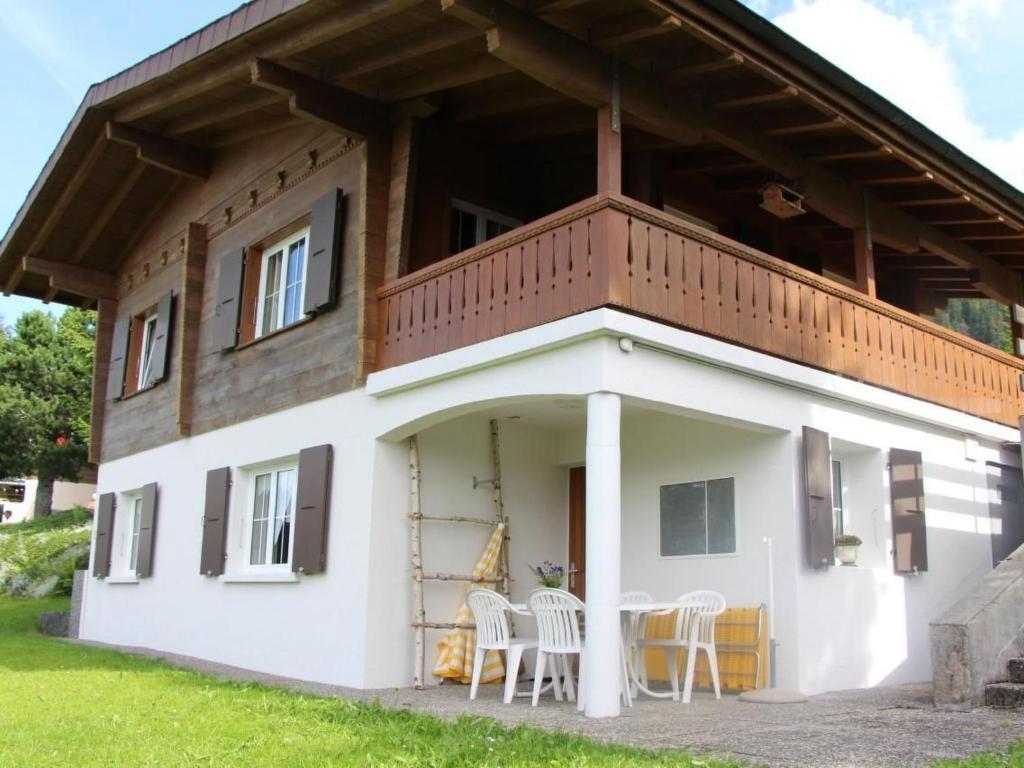 a house with a balcony on top of it at Apartment Huusli by Interhome in Axalp