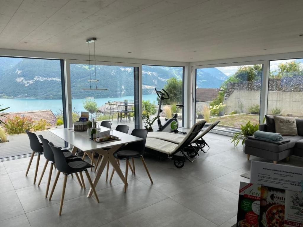 a living room with a table and chairs and a couch at Apartment Gemütliche Apartment by Interhome in Krattigen