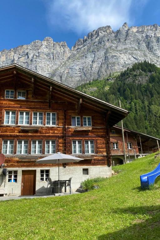a wooden house with a table and a playground at Apartment Alpenruh by Interhome in Gadmen
